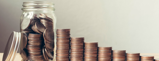 A jar of coins and stacks of pennies.